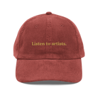 Red cap with 'Listen to artists.' text on a white background