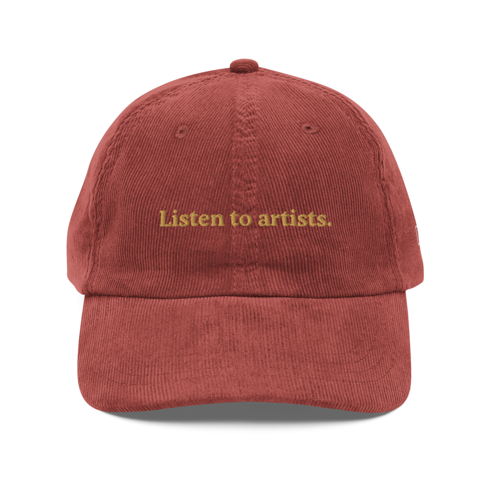 Red cap with 'Listen to artists.' text on a white background