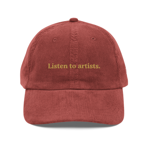 Red cap with 'Listen to artists.' text on a white background