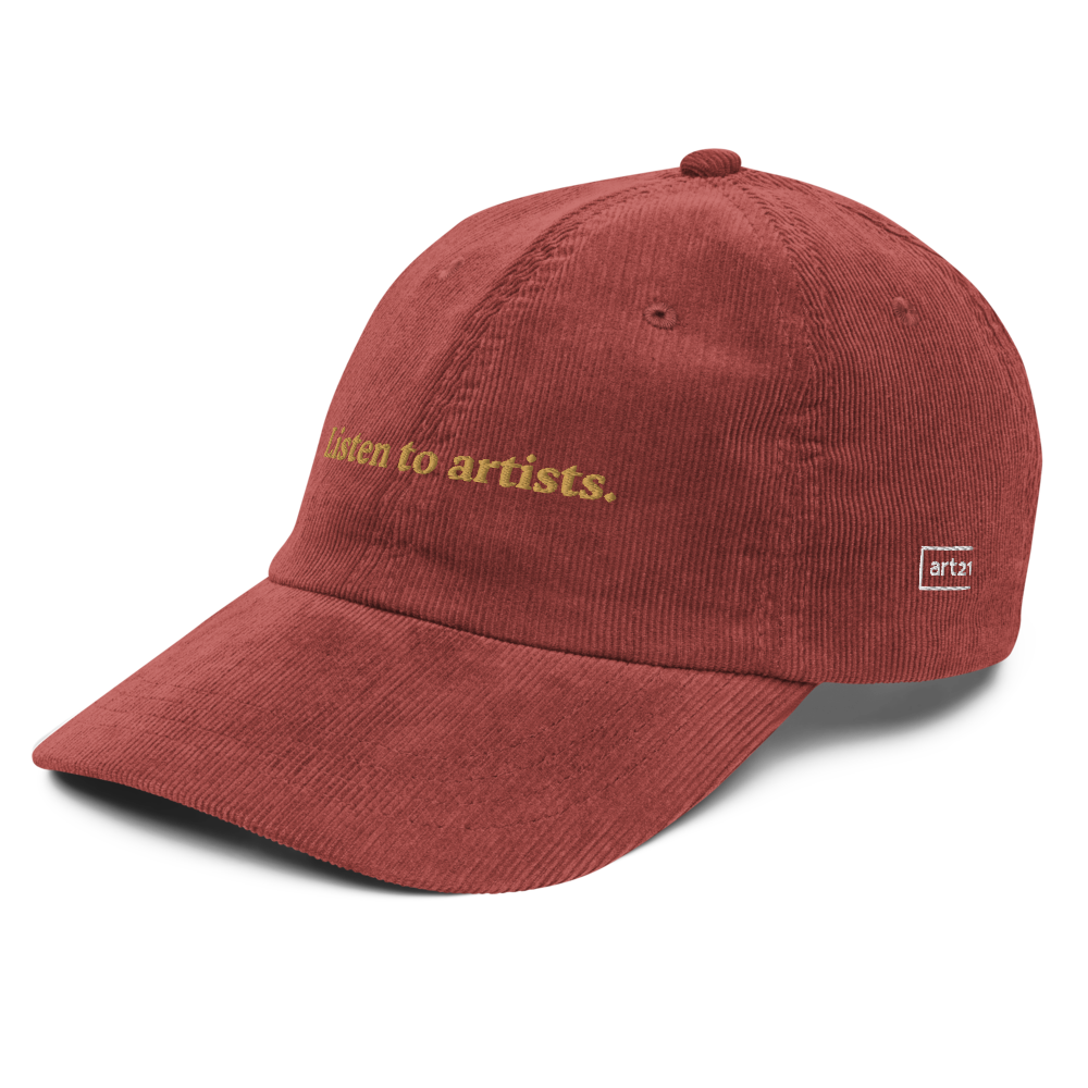 Red cap with 'Listen to artists.' text on a white background